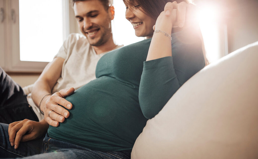 Cheerful couple expecting their first born child