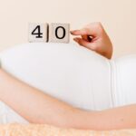 Woman holding 40 blocks on her pregnant belly for being 40 weeks pregnant