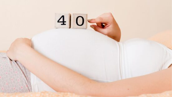 Woman holding 40 blocks on her pregnant belly for being 40 weeks pregnant