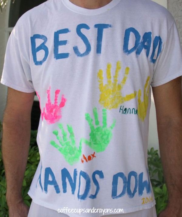 White t-shirt that has BEST DAD EVER, HANDS DOWN written on it with colourful handprints from kids