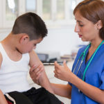 A young boy getting immunised.