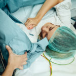 Woman giving birth via c-section