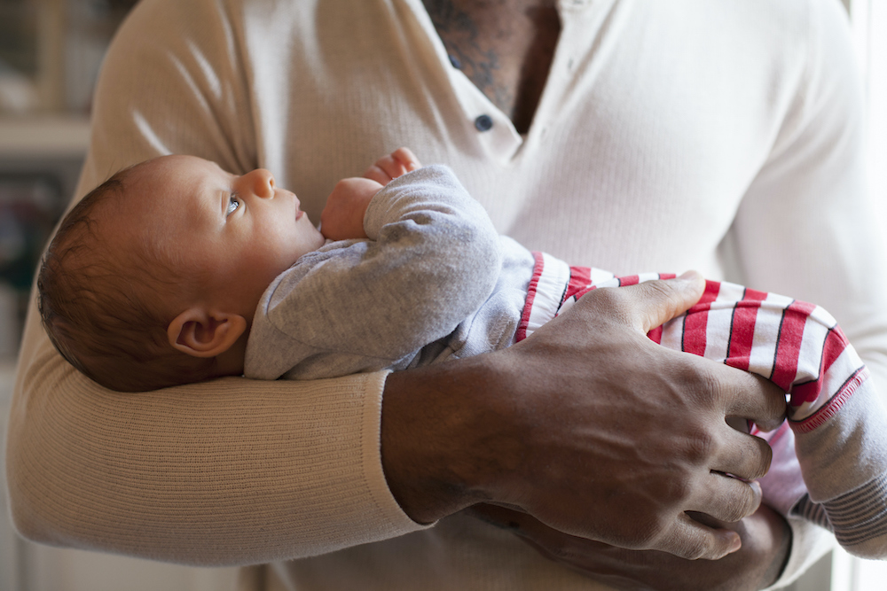 Father holding newborn baby in his arms