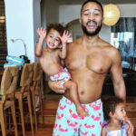 John legend in matching swim wear with children Miles and Luna