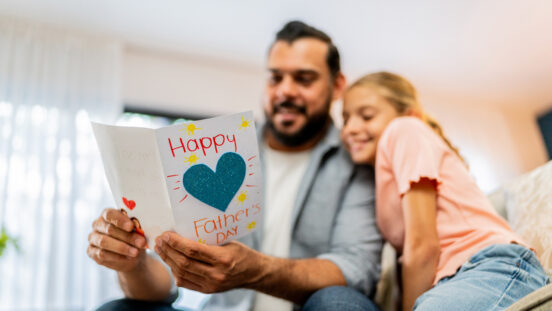 Close-up of father holding a father's day gift at home