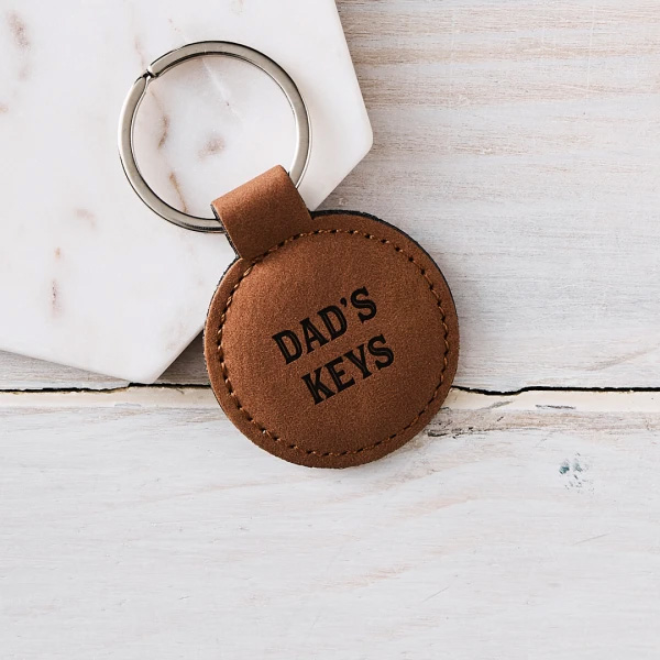 Circular brown leather key fob with DAD'S KEYS printed on it