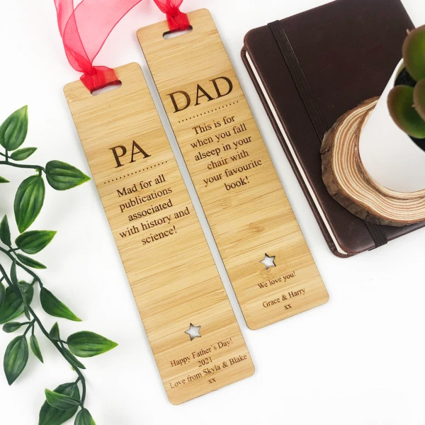 Image of two wood-look personalised bookmarks with red ribbon at the top