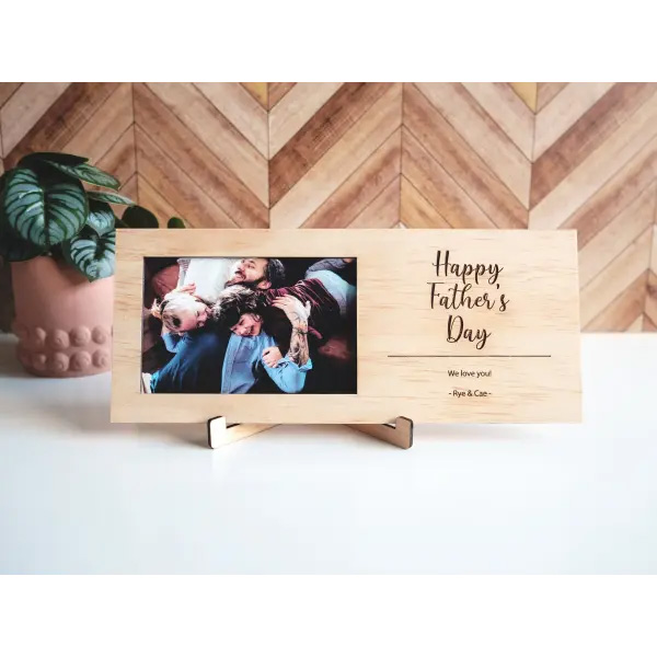 Wooden look picture frame showing a family photo and personalised Father's Day text on the side