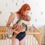 Mother holding her baby in nursery