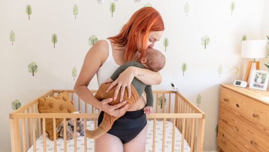 Mother holding her baby in nursery