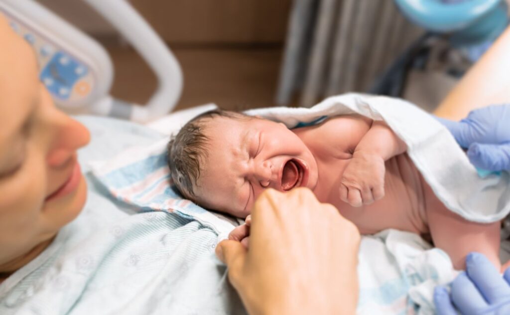 Mother holds her newborn baby in the hospital