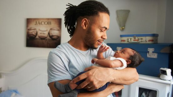 Father looking at newborn baby