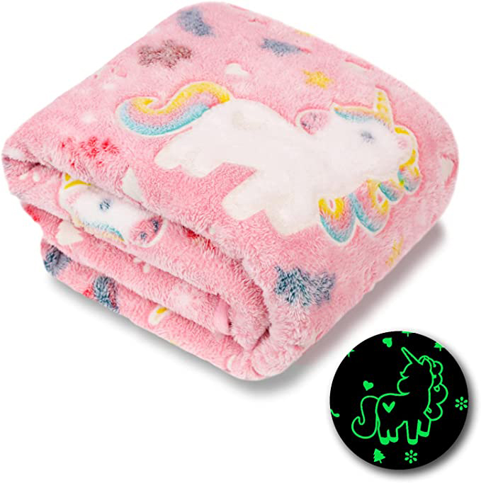 Folded pink fluffy winter unicorn blanket