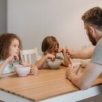 Dad talking to two children