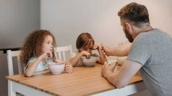 Dad talking to two children