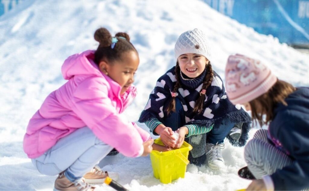 Kids playing at Hunter Valley Gardens snow in the garden