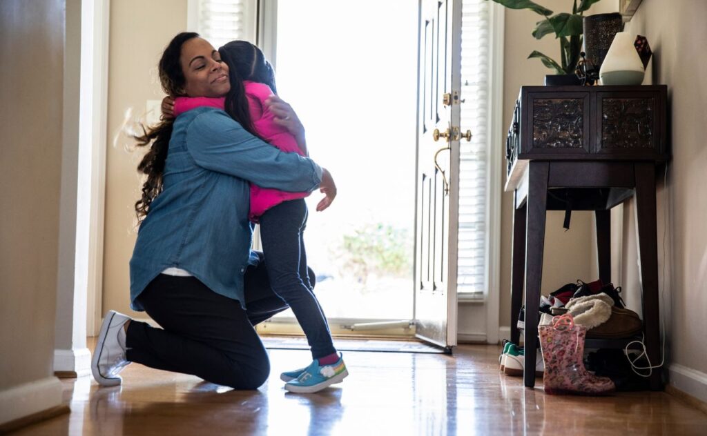 Mother hugging daughter