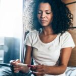 woman looking at pregnancy test