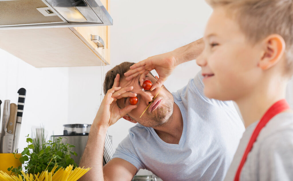 Father and son having fun in the kitchen - stock photo
