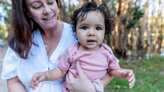 Aboriginal mother holding her cute older baby girl