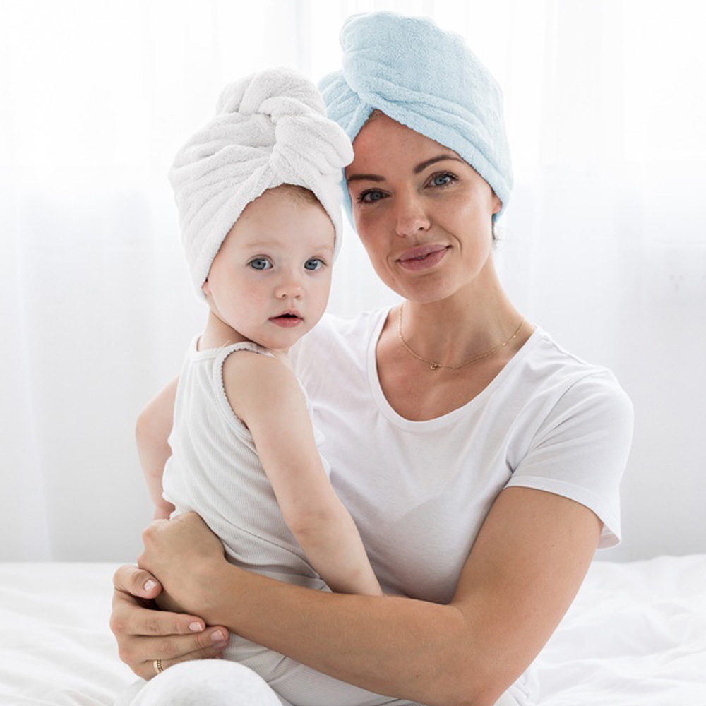 Freshly showered mother and infant wearing silky tots hair wraps to dry hair