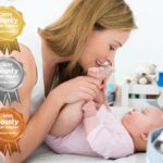 Mother playing with baby on changing table