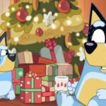 Bluey and Bandit sitting by Christmas tree