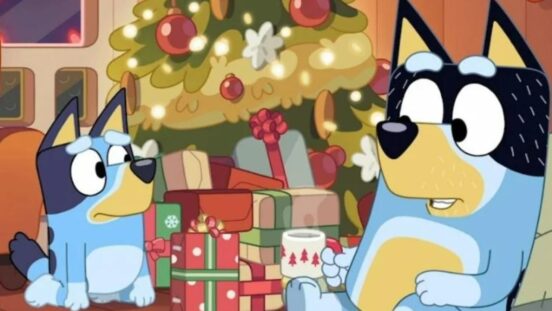 Bluey and Bandit sitting by Christmas tree