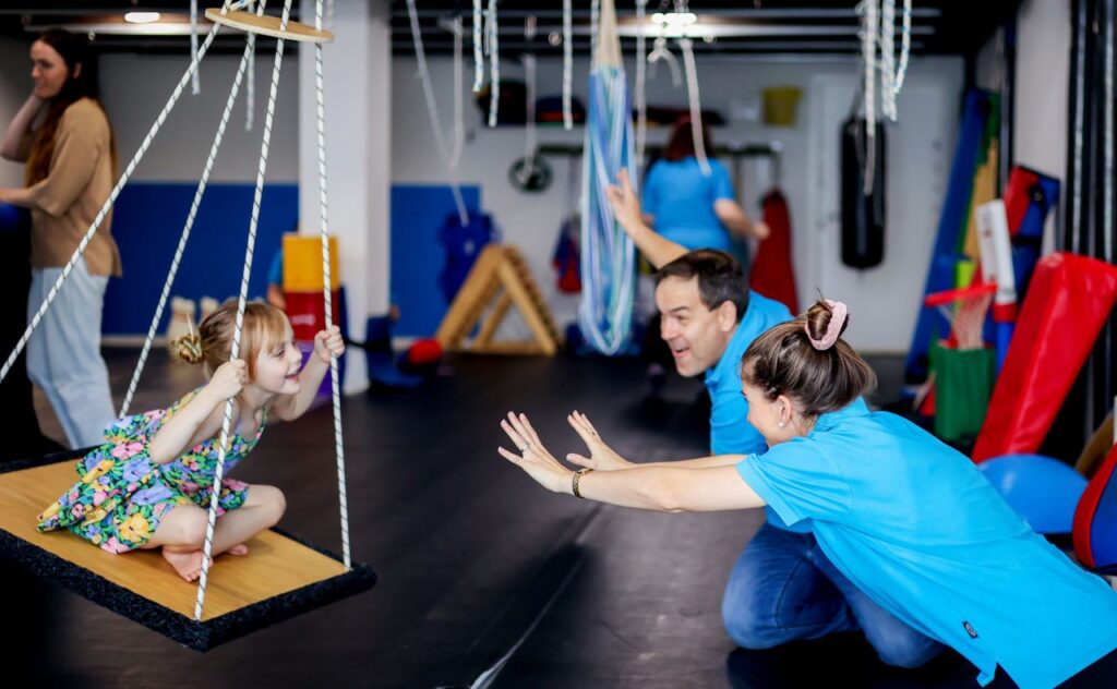 Child on occupational therapist swing