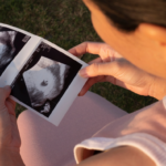 Side view of a woman looking at an early pregnancy scan