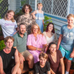 Australian mum, Jeni Bonell and family pose on porch steps.