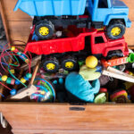 Outdoor toy box staxked high with children's toys.