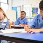 School children in classroom doing work