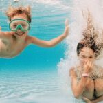 Girl and Boy Underwater in Swimming Pool