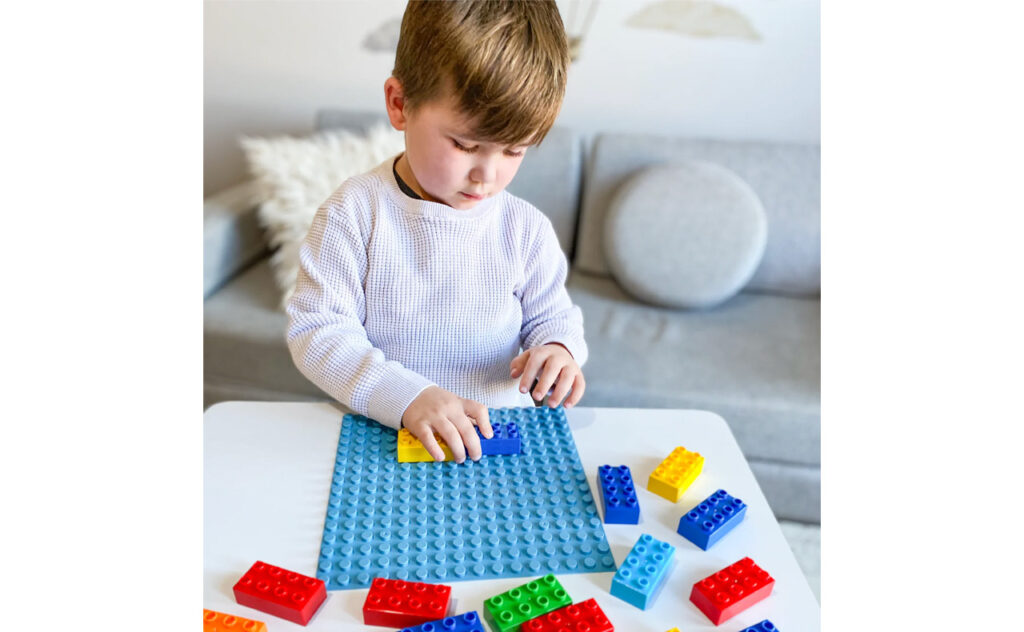 technoference - young boy playing with lego bricks