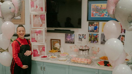 Caterina Mete, a Red Wiggle, surrounded by pink at the Wiggles baby shower for her twin girls