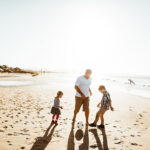 Family playing with the sand on the beach Byron Bay