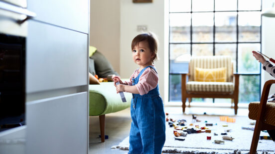 Little girl in denim dungarees playing at home, leisure, childhood, innocence