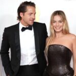 Tom Ackerley and Margot Robbie attend the 96th Annual Academy Awards