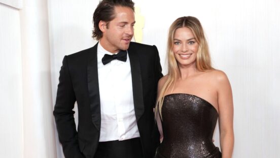 Tom Ackerley and Margot Robbie attend the 96th Annual Academy Awards