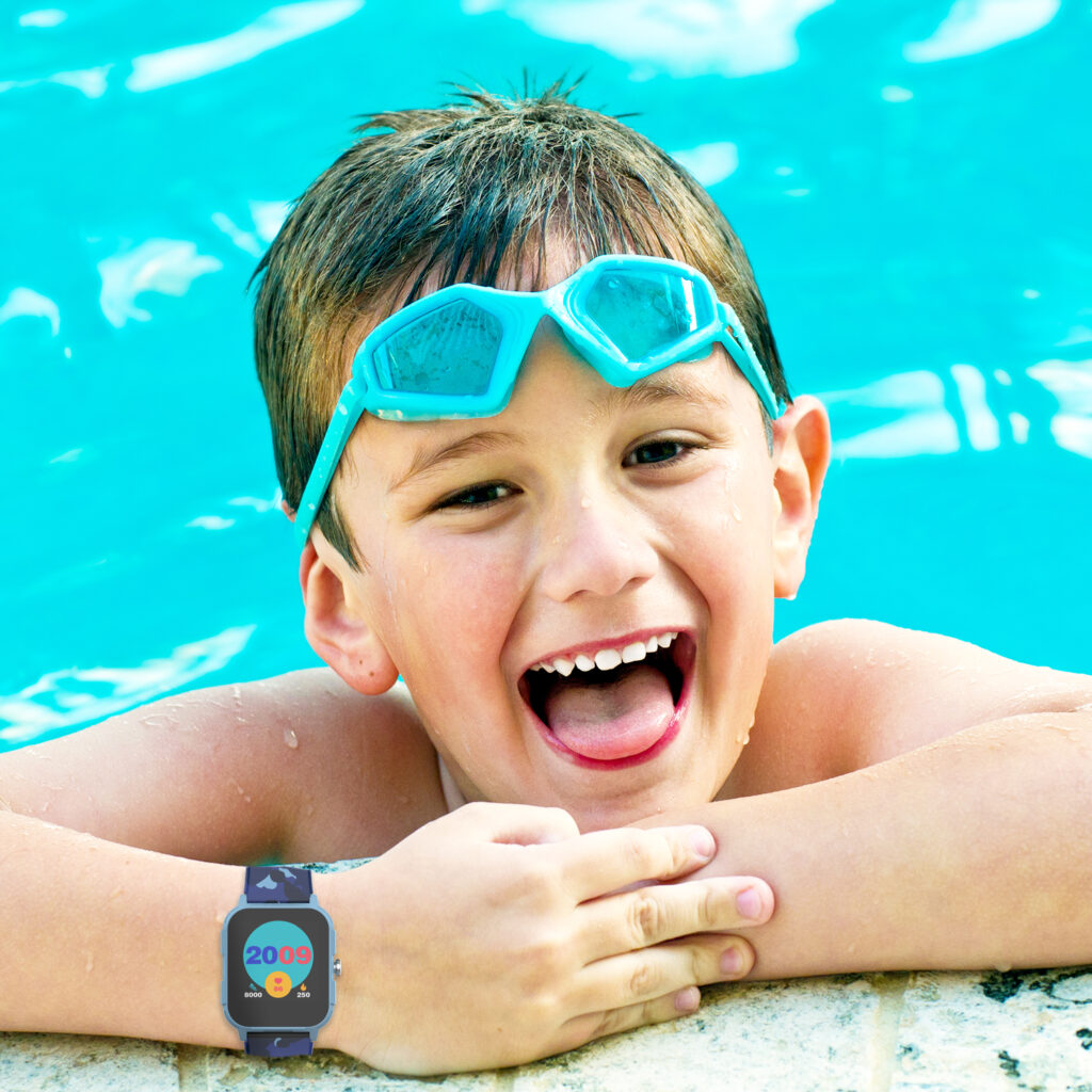 Small boy in pool wearing goggles and a V-Fitness Momentum 2.0 Smart Watch