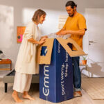 Couple unboxing Emma Sleep mattress in modern living area