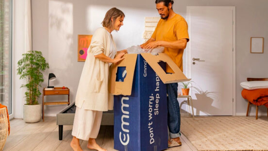 Couple unboxing Emma Sleep mattress in modern living area