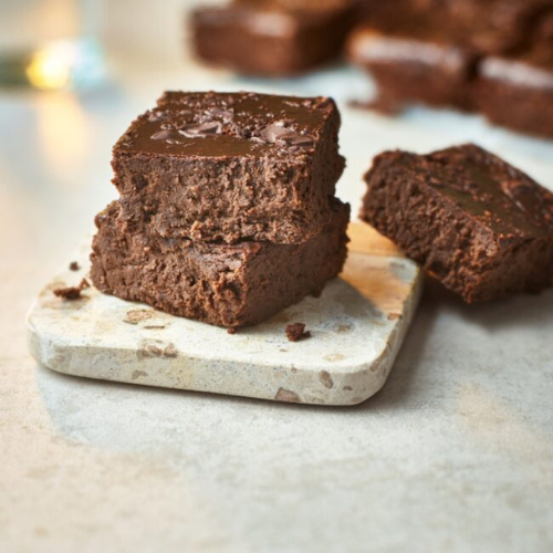 Small marble board with three pieces of healthy chocolate brownie on it