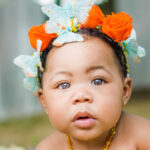 Portrait of baby girl wearing butterflies and flowers in her hair