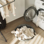 Laundry day on living room with washing machine, basket with clothes and drying clothesline. Modern kitchen with washing machine, dryer and laundry detergent. Laundry day. Routine home chores.