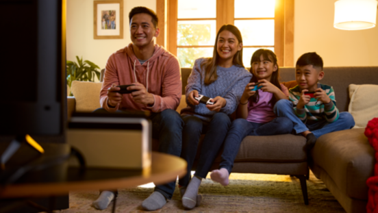 Family of four playing Nintendo Switch together