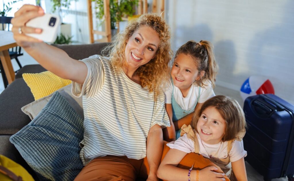 Family selfie with mother and daughters before heading on a holiday