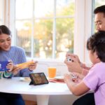 Family of four playing Nintendo Switch together