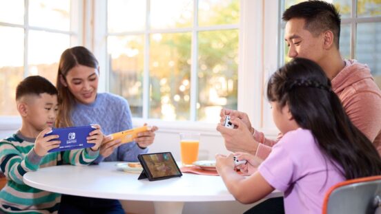 Family of four playing Nintendo Switch together